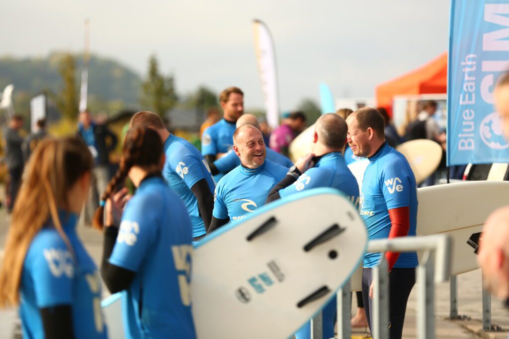 Group socialising by the water at The Wave